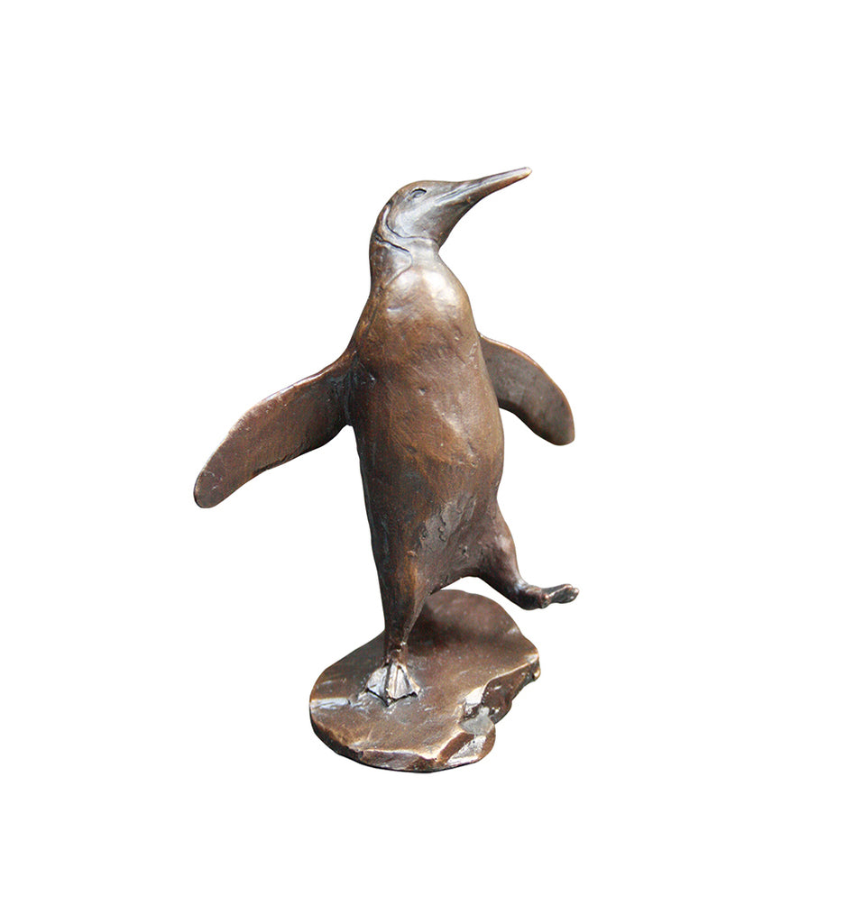 Penguin standing on rock bronze sculpture